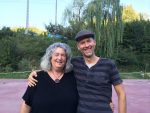 photo of two people, Starhawk and Alfred Decker, smiling with their arms around each other.